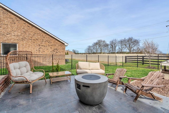 view of patio with an outdoor living space with a fire pit