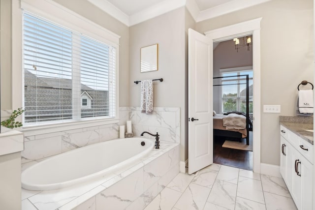 bathroom featuring tiled tub, vanity, a wealth of natural light, and crown molding