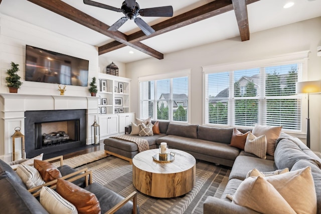 living room featuring beamed ceiling, plenty of natural light, and dark hardwood / wood-style flooring