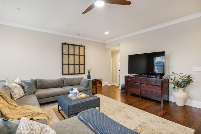 living room featuring hardwood / wood-style flooring, ceiling fan, and crown molding