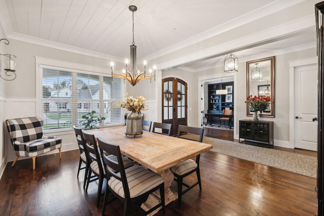 dining room with ornamental molding, dark wood-type flooring, a chandelier, and french doors