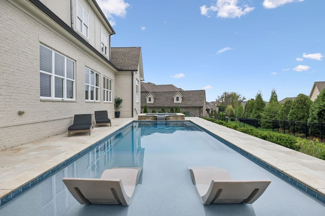 view of swimming pool featuring an in ground hot tub