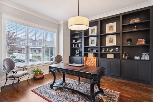 office area with dark hardwood / wood-style flooring, crown molding, and built in shelves