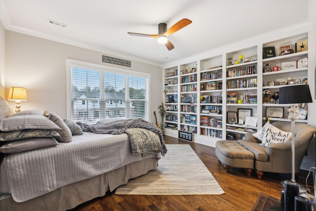 bedroom with crown molding, ceiling fan, and dark hardwood / wood-style flooring