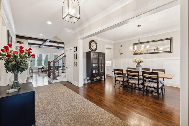 dining area with crown molding, ceiling fan with notable chandelier, dark hardwood / wood-style floors, and beamed ceiling