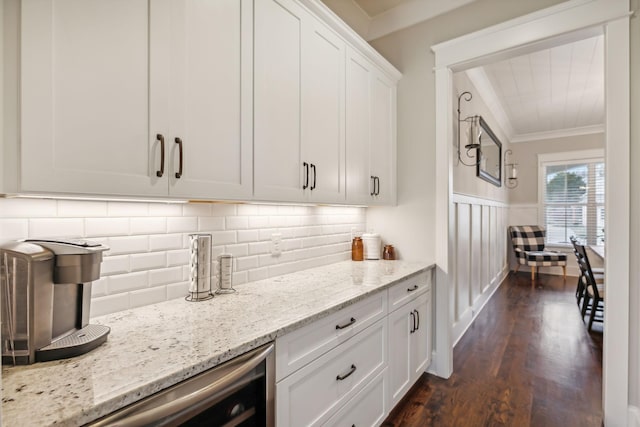 bar with white cabinetry, crown molding, dark hardwood / wood-style flooring, light stone countertops, and decorative backsplash