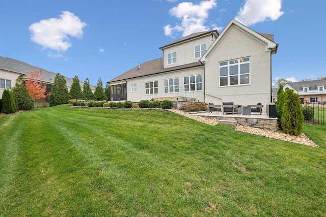 rear view of house featuring a yard and a patio area