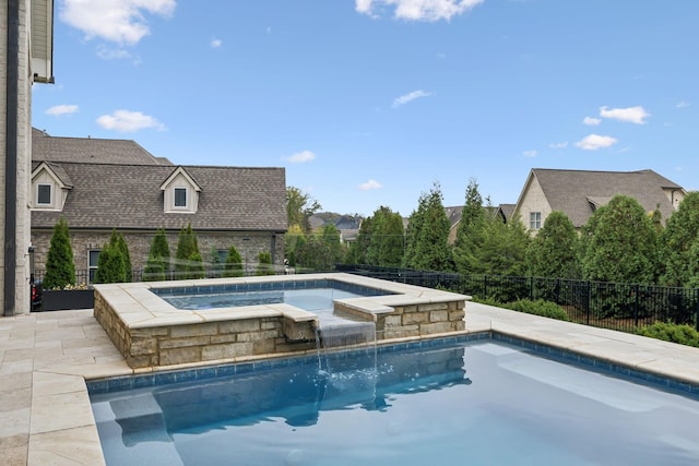 view of swimming pool with an in ground hot tub