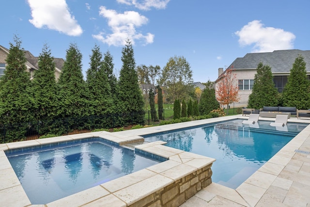 view of swimming pool with an outdoor hot tub