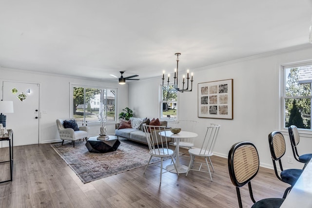 living room with crown molding, ceiling fan, and light wood-type flooring