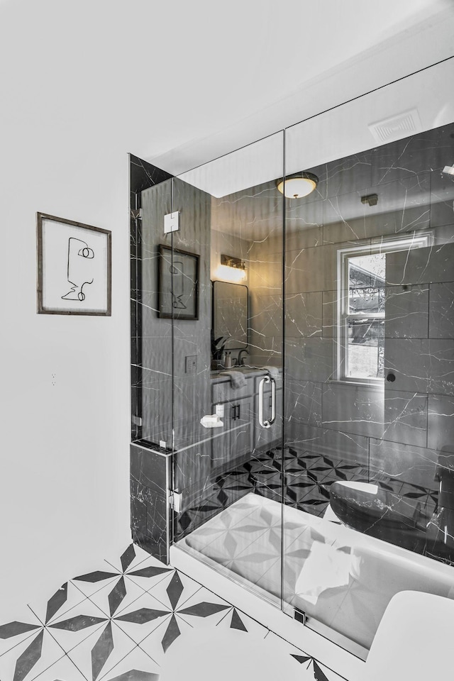 bathroom featuring a shower with shower door