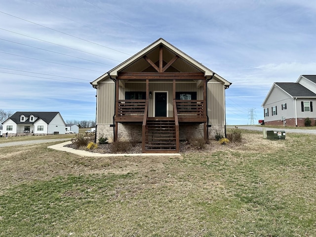 view of front of home featuring covered porch, board and batten siding, a front yard, and stairs