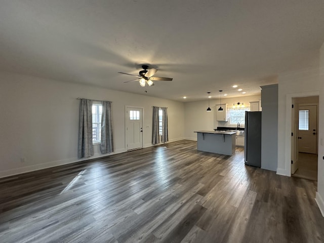 unfurnished living room featuring dark wood-style floors, recessed lighting, baseboards, and a ceiling fan