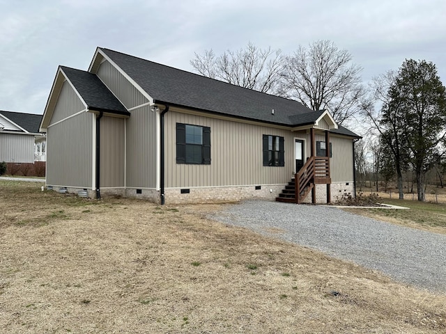 view of front of home with a shingled roof and crawl space