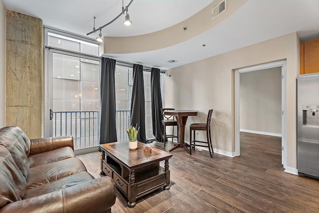 living room featuring floor to ceiling windows and dark wood-type flooring