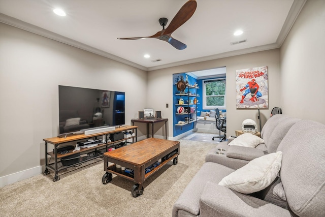 living area featuring a ceiling fan, visible vents, and crown molding