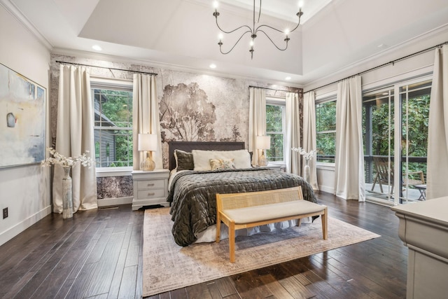 bedroom featuring dark wood-style flooring, baseboards, access to outside, a raised ceiling, and crown molding