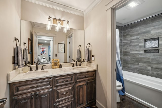 full bath featuring ornamental molding, a sink, toilet, and double vanity