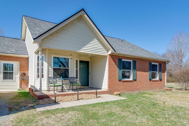 view of front facade with a front lawn and a porch