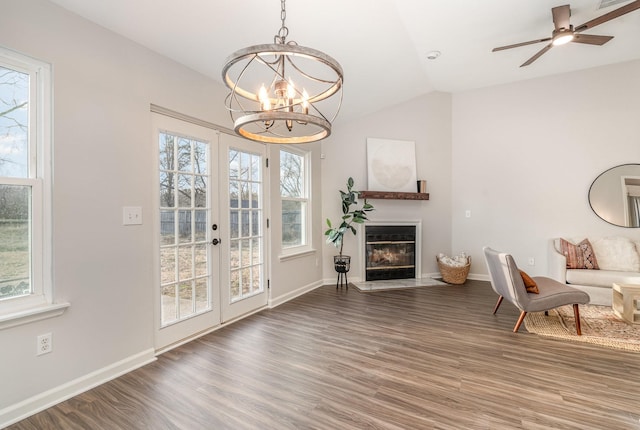 sitting room featuring lofted ceiling, french doors, wood finished floors, and a glass covered fireplace