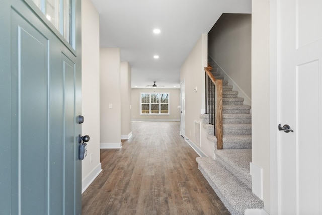 entrance foyer featuring recessed lighting, dark wood-style flooring, visible vents, baseboards, and stairway