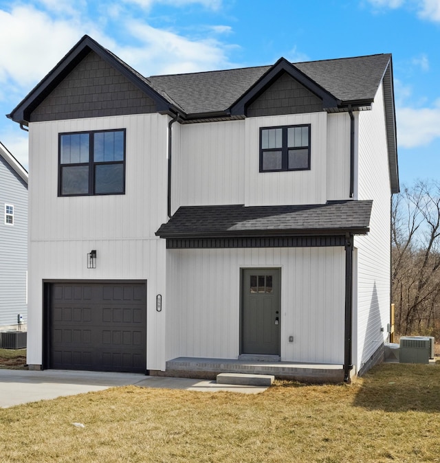 modern farmhouse featuring an attached garage, a shingled roof, central AC, and a front yard