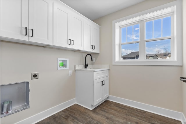 clothes washing area featuring dark wood finished floors, hookup for a washing machine, hookup for an electric dryer, a sink, and baseboards