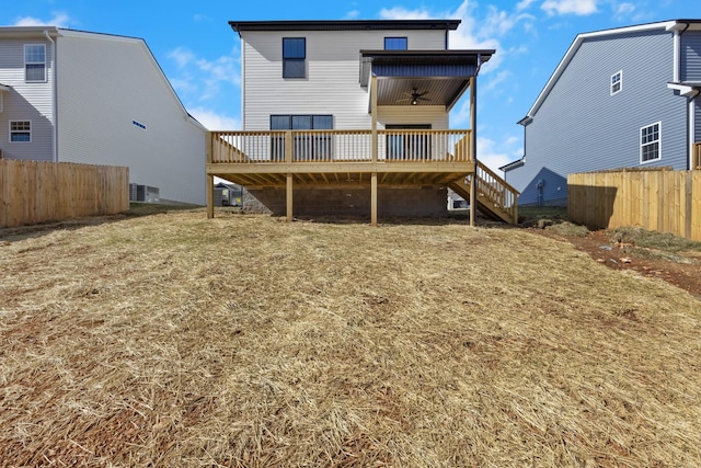 rear view of house with ceiling fan, fence, a wooden deck, and stairs