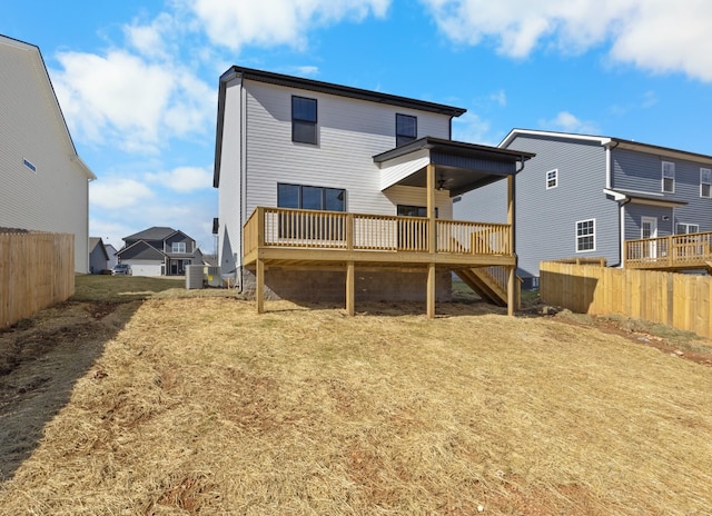 back of property featuring a deck, central AC unit, and fence