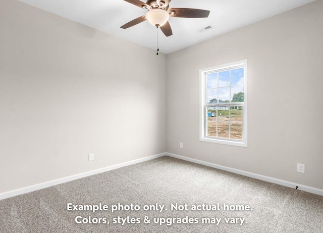 carpeted spare room with ceiling fan