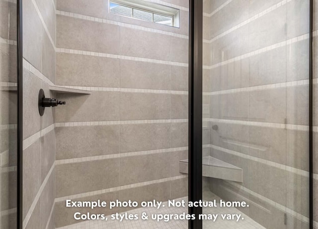 bathroom featuring a shower with shower door