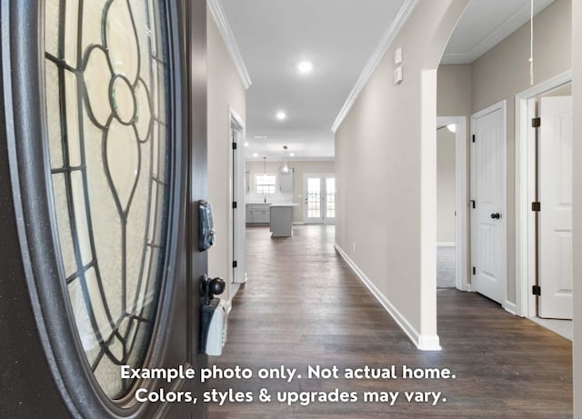 interior space featuring crown molding and dark wood-type flooring