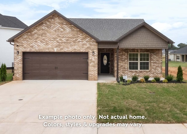 view of front of house with a garage and a front yard