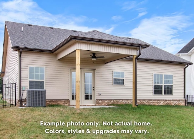 back of property featuring ceiling fan, central AC unit, and a lawn