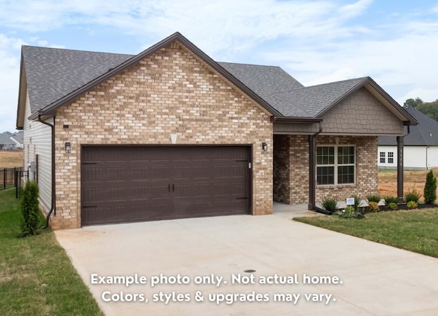 view of front of house featuring a garage and a front lawn