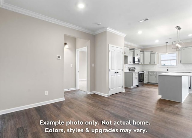 kitchen featuring stainless steel appliances, a kitchen island, hanging light fixtures, and ornamental molding