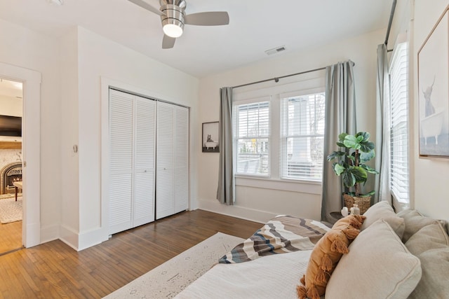 bedroom featuring hardwood / wood-style flooring, a closet, and ceiling fan