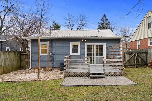 back of house featuring a patio, a yard, and a deck