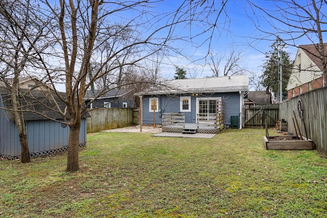 rear view of house featuring a yard and a patio