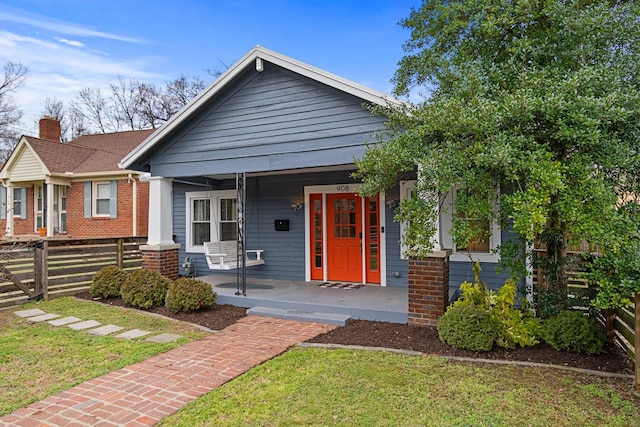 view of front of house with a porch and a front lawn