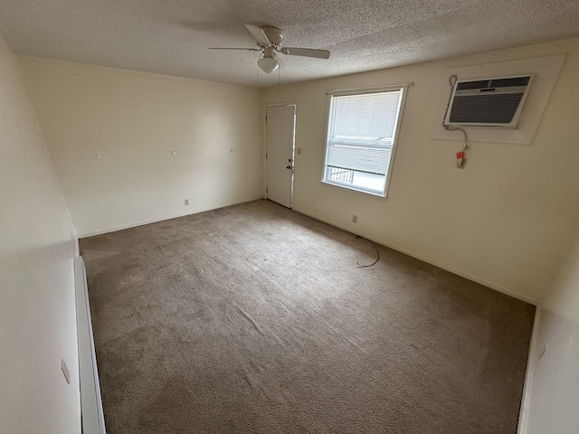 unfurnished room with ceiling fan, a wall unit AC, a textured ceiling, and dark carpet