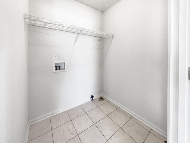 washroom featuring washer hookup and light tile patterned floors