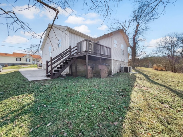 rear view of property featuring a patio, a yard, cooling unit, and a deck