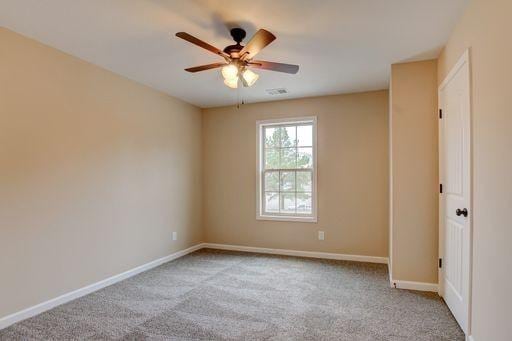 carpeted empty room featuring ceiling fan