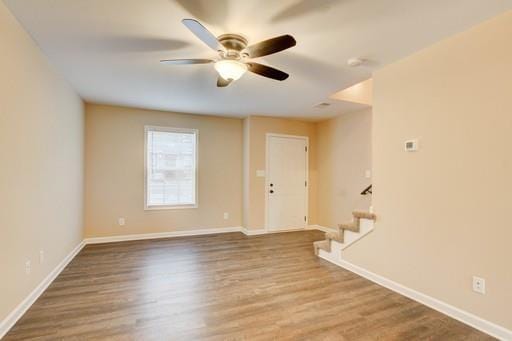 empty room with hardwood / wood-style flooring and ceiling fan