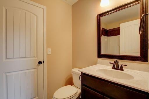 bathroom with vanity, toilet, and radiator heating unit