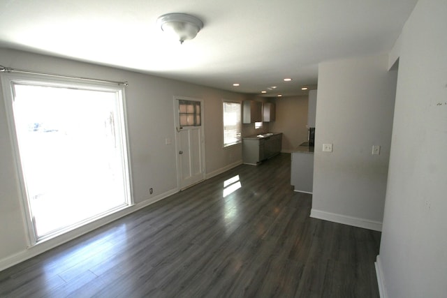 interior space with recessed lighting, dark wood finished floors, and baseboards