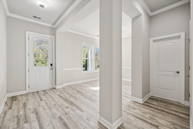 entrance foyer with ornamental molding and light wood-type flooring