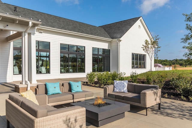 view of patio / terrace featuring an outdoor living space with a fire pit