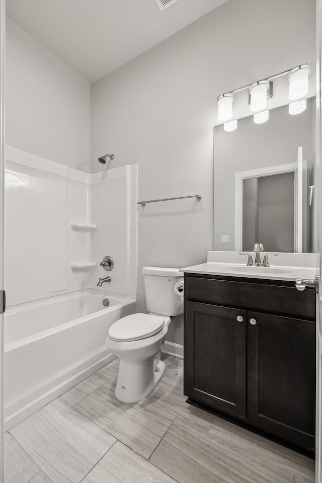 full bathroom featuring shower / bathtub combination, vanity, and toilet